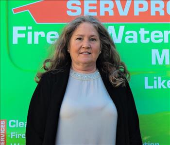 Woman standing in front of a SERVPRO truck