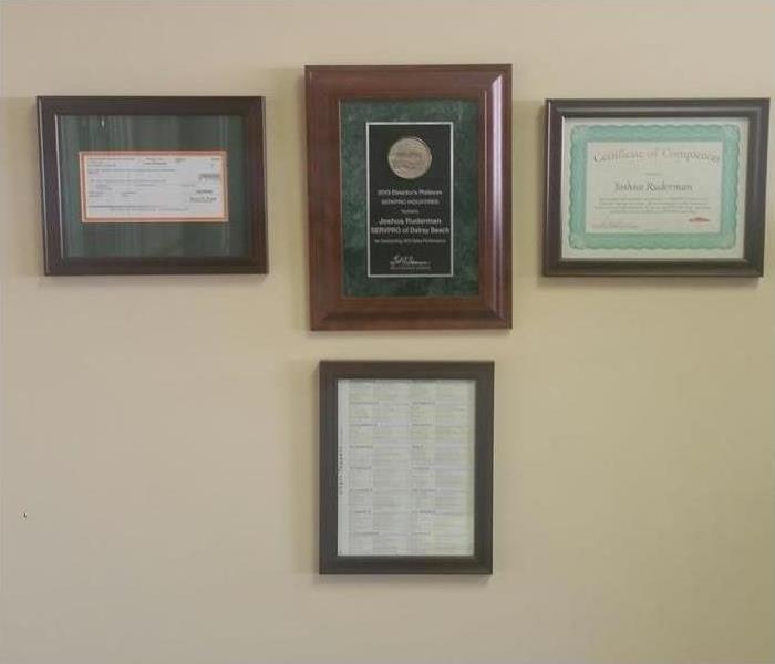 Acknowledgements and rewards hanging on wall.