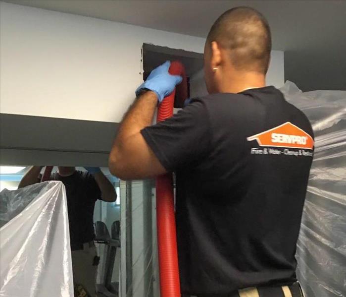 servpro employee cleaning air ducts