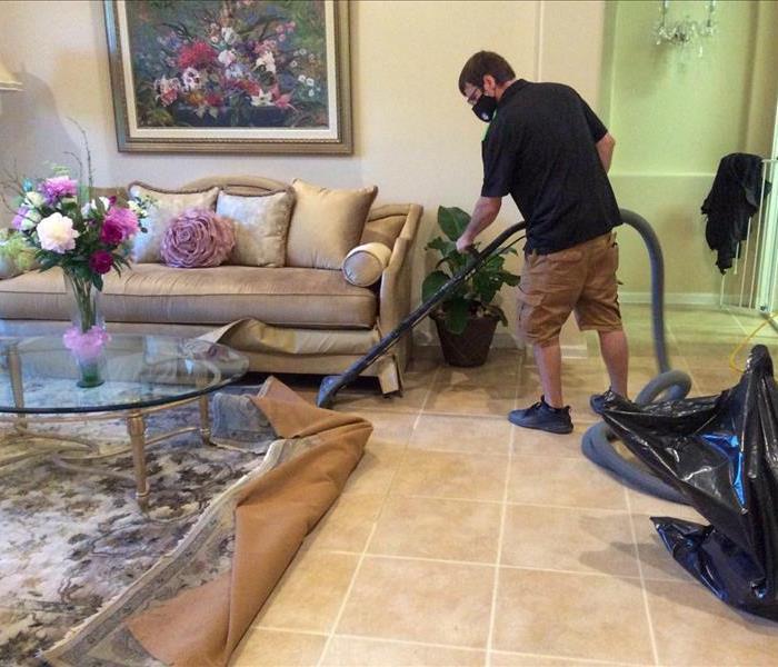SERVPRO tech removing the water from the floor of a Delray Beach, FL home